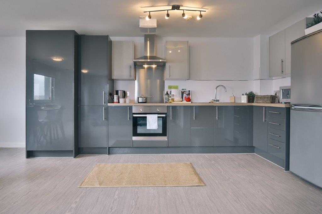 Modern grey cupboards line the walls in a kitchen space in Marsden House