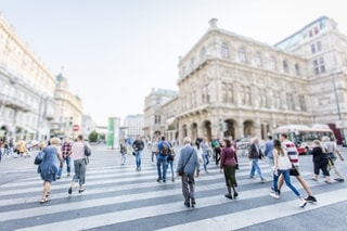 Crowd of people walking on busy city street