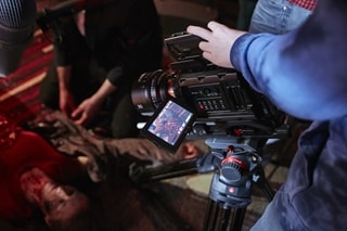 Camera and crew filming scene