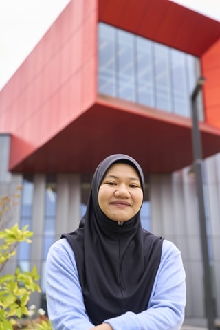 A Malaysian girl with a head scarf sat in front of CSS building